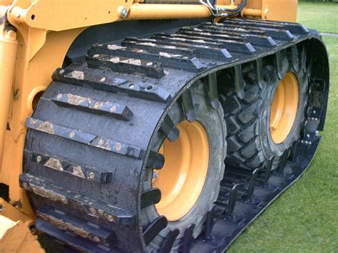 skid steer over the tire tracks|skid loader tracks over tires.